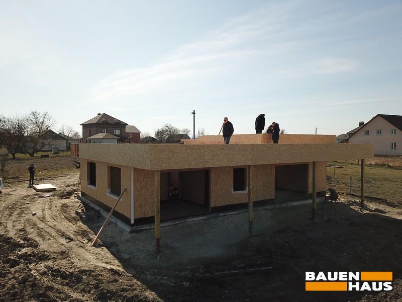 В доме просторная терраса с большим остеклением